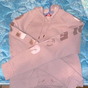 Rose gold hoodie by Guess.